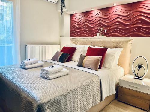 a bedroom with a large bed with towels on it at eliTe deluxe 2 in Kavala