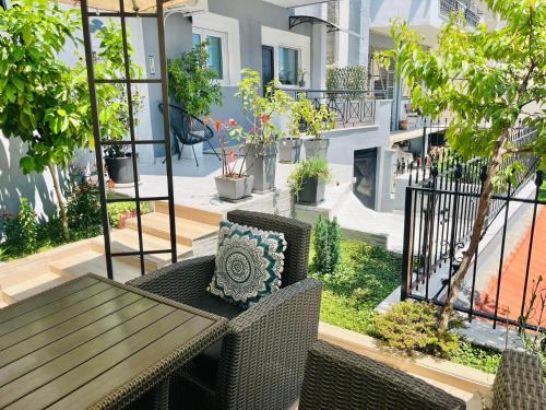a patio with a table and chairs and plants at eliTe deluxe 2 in Kavala