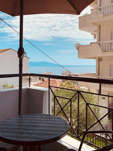 a table on a balcony with a view of a city at eliTe deluxe 2 in Kavala