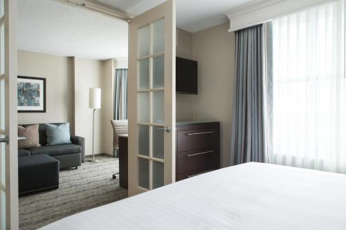 a hotel room with a bed and a couch at Homewood Suites By Hilton Downers Grove Chicago, Il in Downers Grove