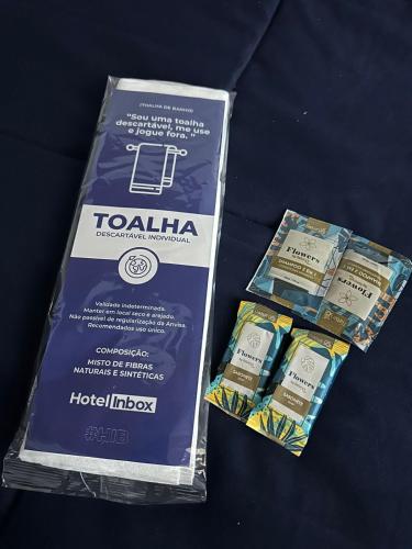 two boxes of toothpaste are sitting on a table at Hotel In Box in Irati