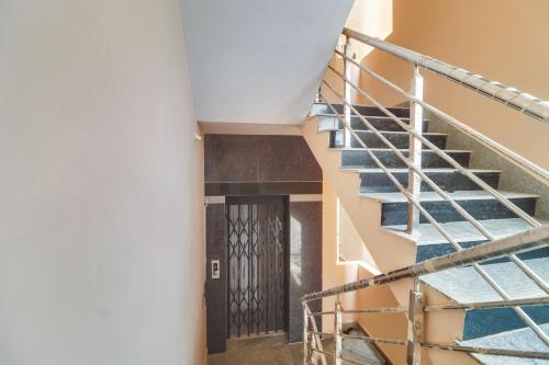 a spiral staircase in a building with a door at Super OYO Collection O Hotel Sbr Luxury Rooms in Hyderabad