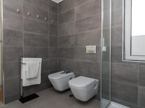 a bathroom with a toilet and a glass shower at Luxury House - Privat Heated Pool & Ecologic & BBQ & Privacy & Albufeira in Albufeira