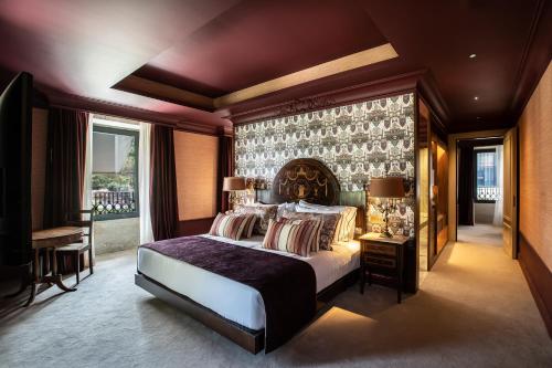 a bedroom with a large bed and a large window at Vinha Boutique Hotel - The Leading Hotels of the World in Vila Nova de Gaia