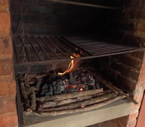 a brick oven with a fire in it at Sinadan in Barbosa