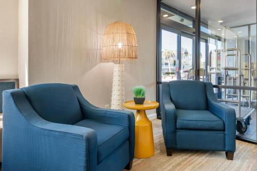 two blue chairs and a lamp in a room at Surf and Sand Fernandina Beach at Amelia Island, an Ascend Collection Hotel in Fernandina Beach