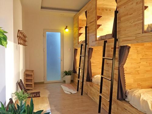 a room with two bunk beds and a hallway at Nhà Nhi Đà Lạt in Da Lat