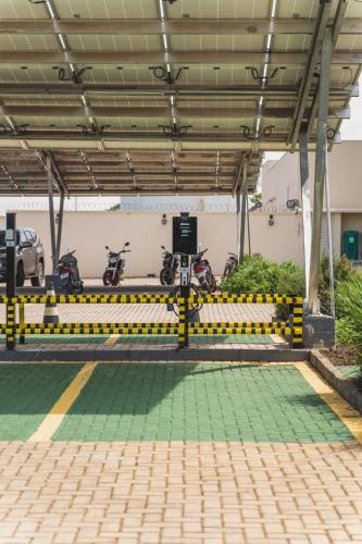 a parking lot with motorcycles parked in a parking garage at Strassen Hotel in Goiânia