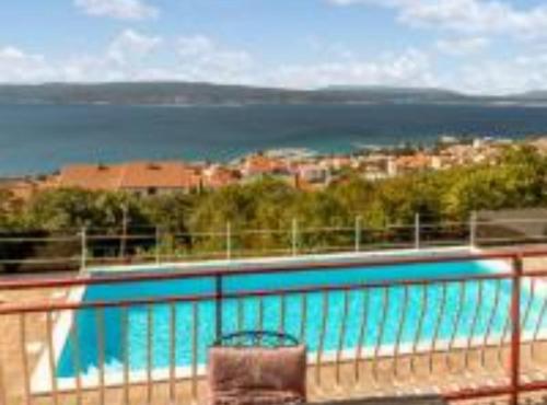 a swimming pool with a view of the water at Apartments Panorama in Crikvenica