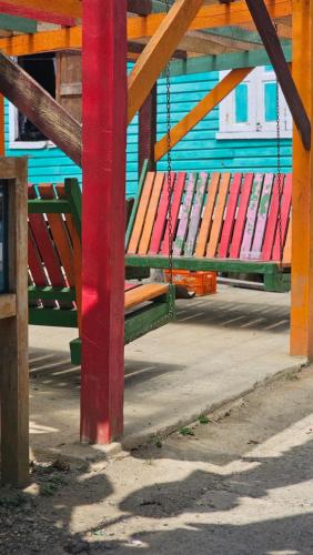 a colorful bench is chained to a building at Bastimentos Hill Guest House in Bocas del Toro