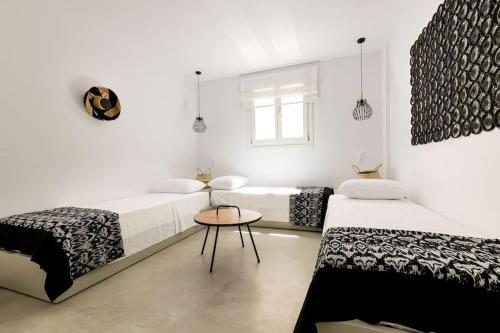 a white room with two beds and a table at Villa with private pool in Dhriopís