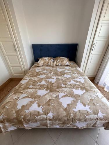 a bed with a blue headboard in a bedroom at LUXUEUSE VILLA AVEC PISCINE PRIVEE PROCHE D'AGADIR in Agadir