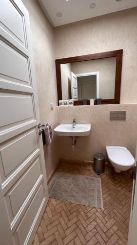 a bathroom with a sink and a toilet and a mirror at LUXUEUSE VILLA AVEC PISCINE PRIVEE PROCHE D'AGADIR in Agadir