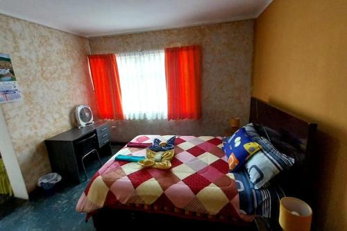 um quarto com uma cama com um edredão colorido em Apartamento privado en Pueblo Libre em Lima