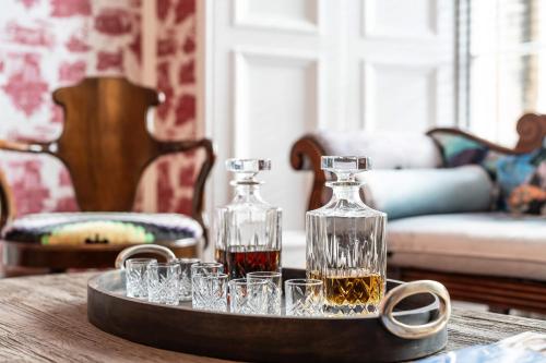 a tray with two bottles and glasses on a table at The Scott in Edinburgh