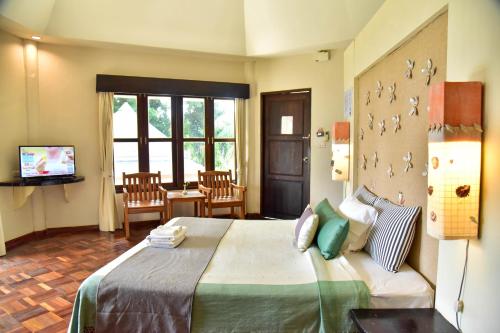 Postel nebo postele na pokoji v ubytování Tanaosri Resort Pranburi