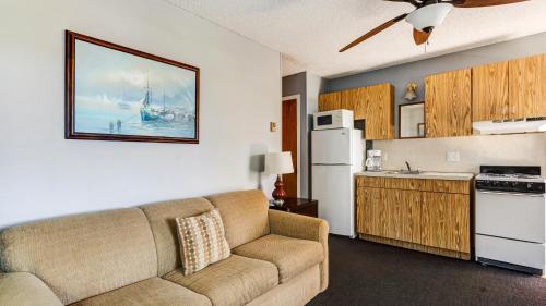 a living room with a couch and a kitchen at Montauk Oceanside Suites in Montauk