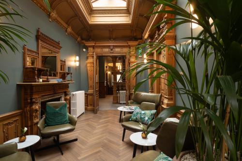 a waiting room with chairs and a fireplace at The Scott in Edinburgh