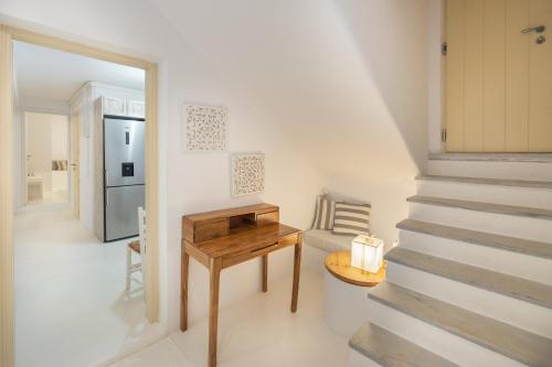a room with a table and a stair case at Villa Nausithoe 1 Paros in Logaras