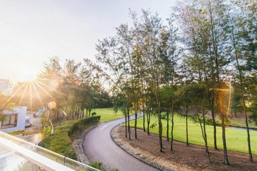 a winding road in a park with trees at Sea Villa - FLC Sam Son in Sầm Sơn