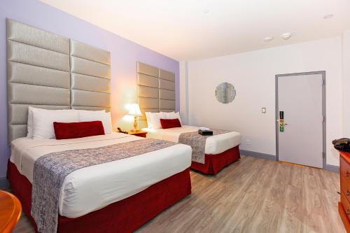 a hotel room with two beds and a table at Hotel St. James in New York