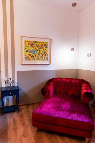 a red couch in a living room with a table at Rezident in Bucharest