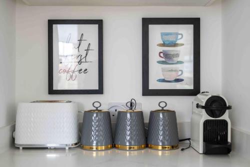 a kitchen counter with three toasters and a microwave at The Lymington Hub Slps 13 hot tub/chef/spa in Lymington
