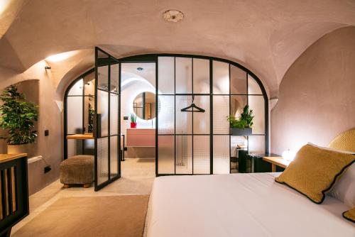 a bedroom with a bed with a large glass door at 7oaks Noble House in Dubrovnik