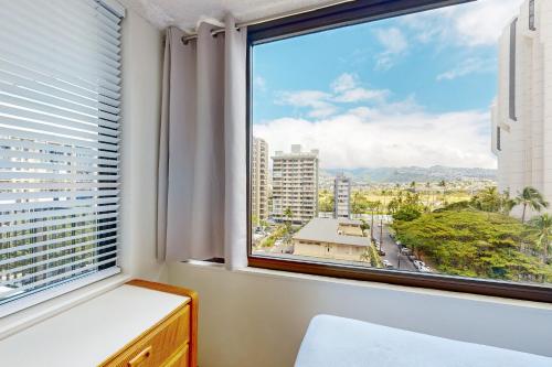 a window with a view of a city at Waikiki Banyan 913 in Honolulu