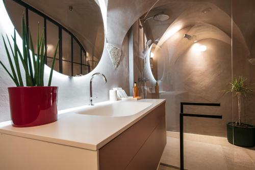a bathroom with a sink and a potted plant at 7oaks Noble House in Dubrovnik
