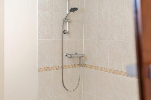 a shower with a shower head in a bathroom at FREE Parking Spacious 2BR Flat in Irlam in Irlam