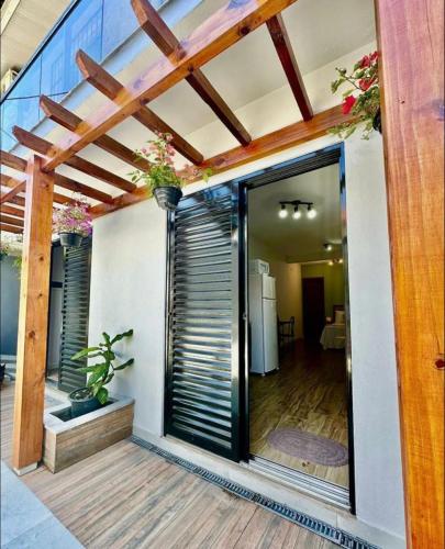 a house with a glass door leading to a patio at Espaço da Zilda in São José