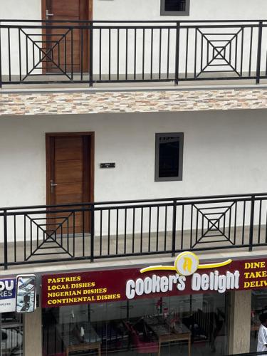 a building with a balcony and a sign for a restaurant at American mall in Accra