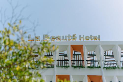 a hotel sign on the side of a building at La Beaute Hotel - Quy Nhơn in Quy Nhon