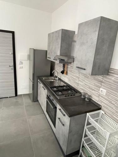 a kitchen with a stove and a sink at Cloud's Home in Tropea