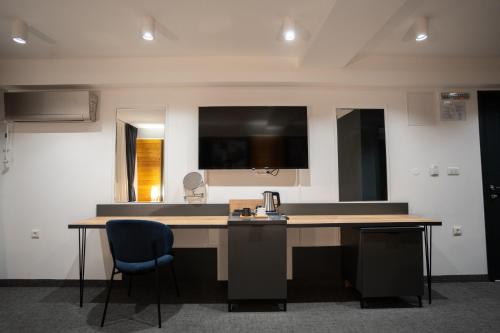 an office with a desk and two chairs in a room at Velkov Apartments in Vinica