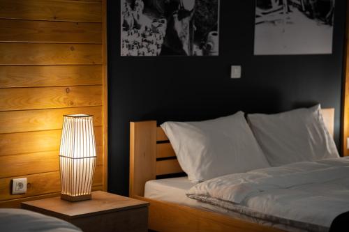 a bedroom with a bed and a lamp on a table at Velkov Apartments in Vinica