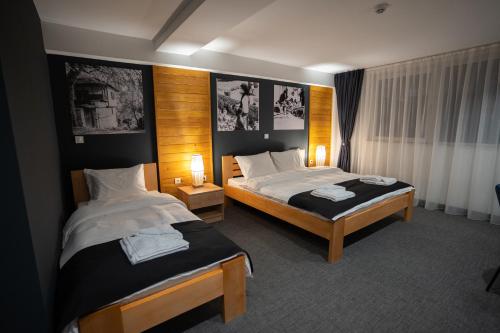 a hotel room with two beds and two lamps at Velkov Apartments in Vinica