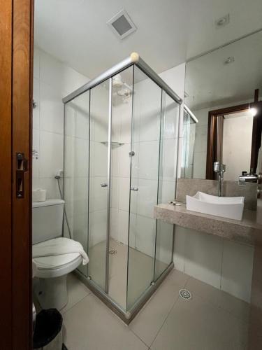 a bathroom with a shower and a toilet and a sink at Mcz Hotel in Maceió
