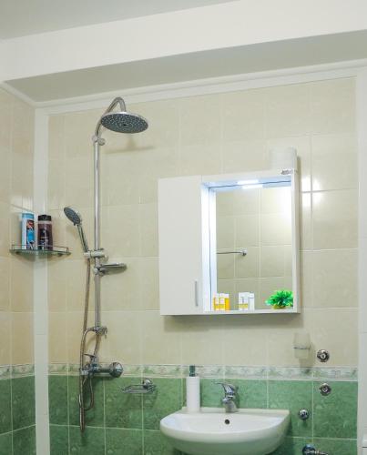 a bathroom with a sink and a mirror at Family Hotel Gotse Delchev in Gotse Delchev