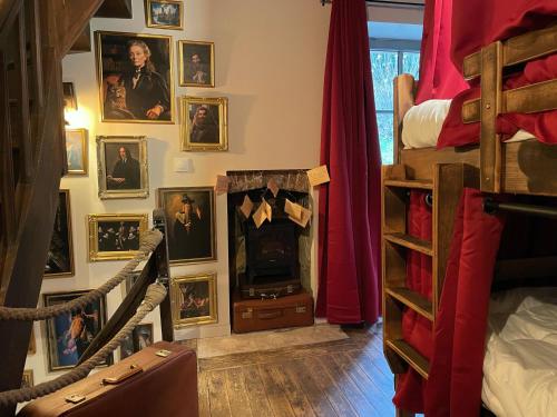 a room with a wall of pictures on the wall at Impasse des Mystères - La maison des Sorciers Léhon/Dinan in Dinan
