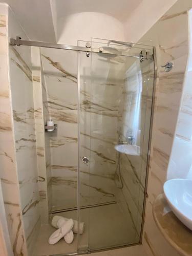 a glass shower in a bathroom with a sink at Eureka luxury room in Ostuni