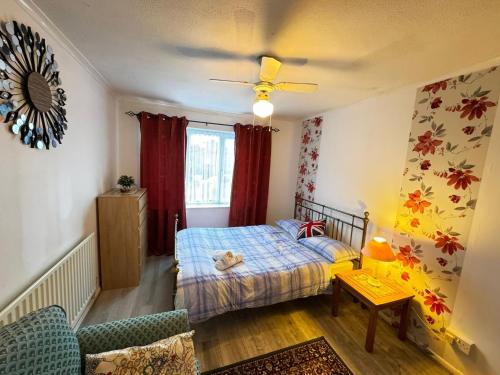 a small bedroom with a bed and a window at Two Double Bedroom Maisonette with rear garden. 