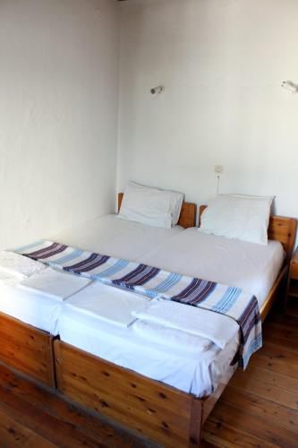 two beds sitting next to each other in a room at Sotos pension in Skopelos Town