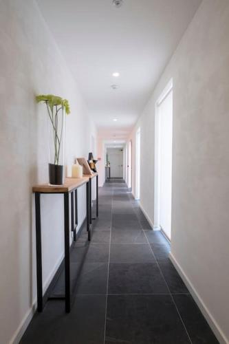 a hallway with a row of tables in a building at Familie & Vriendenwoning met fantastisch uitzicht in Ellezelles