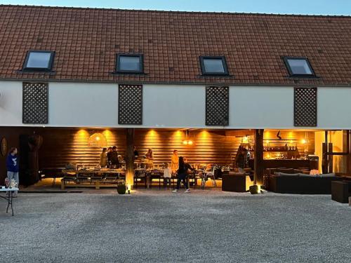 a large building with people standing in front of it at Familie & Vriendenwoning met fantastisch uitzicht in Ellezelles