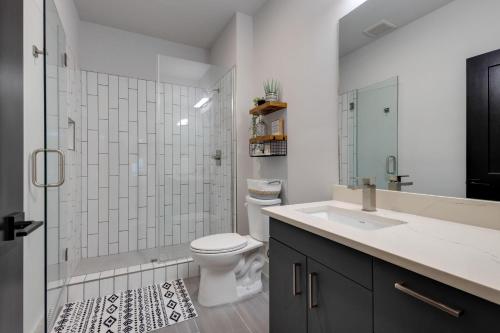 a bathroom with a toilet and a shower and a sink at Hygge - Odyssey - Heart of Midtown in Nashville