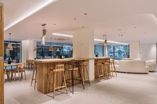 a kitchen with a bar with stools at SKYLA Studios & Suites - Kondapur in Hyderabad
