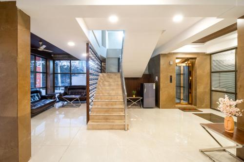 a staircase in a house with a lobby at Monday Hotels Swarnas The Capital in Vijayawāda
