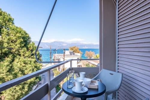 a balcony with a table and a view of the water at Selianitika Bay Apartment B1 in Selianitika